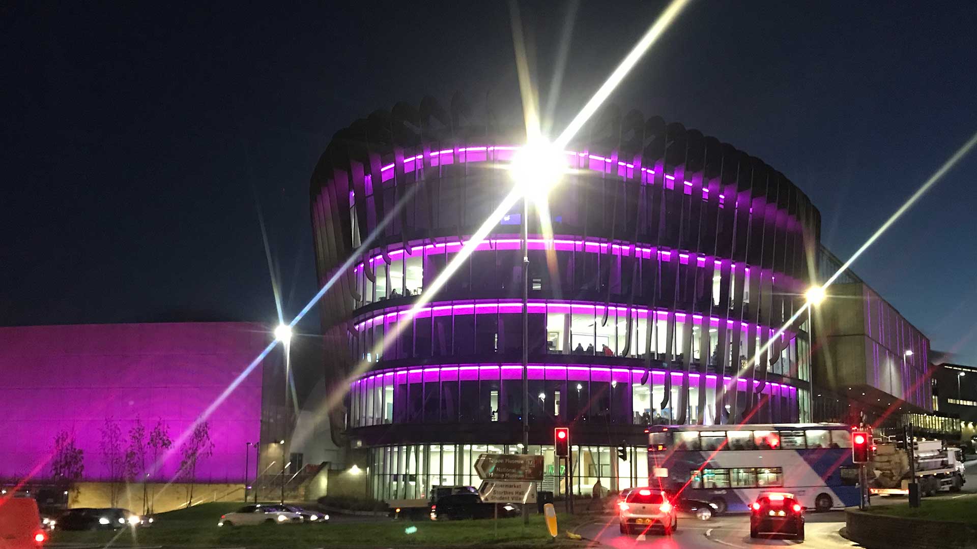 Oastler in purple lights for Disability Day taken from roundabout 