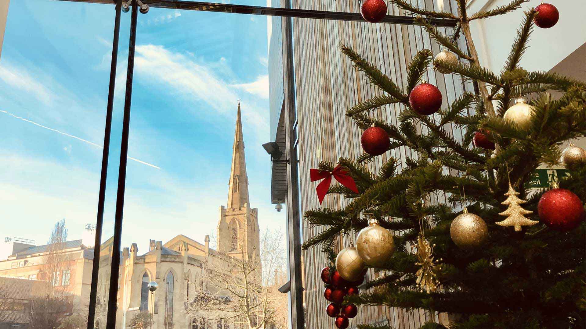 Picture of St Pauls as seen through the window of the Richard Steinitz Building. A Christmas tree is in view.