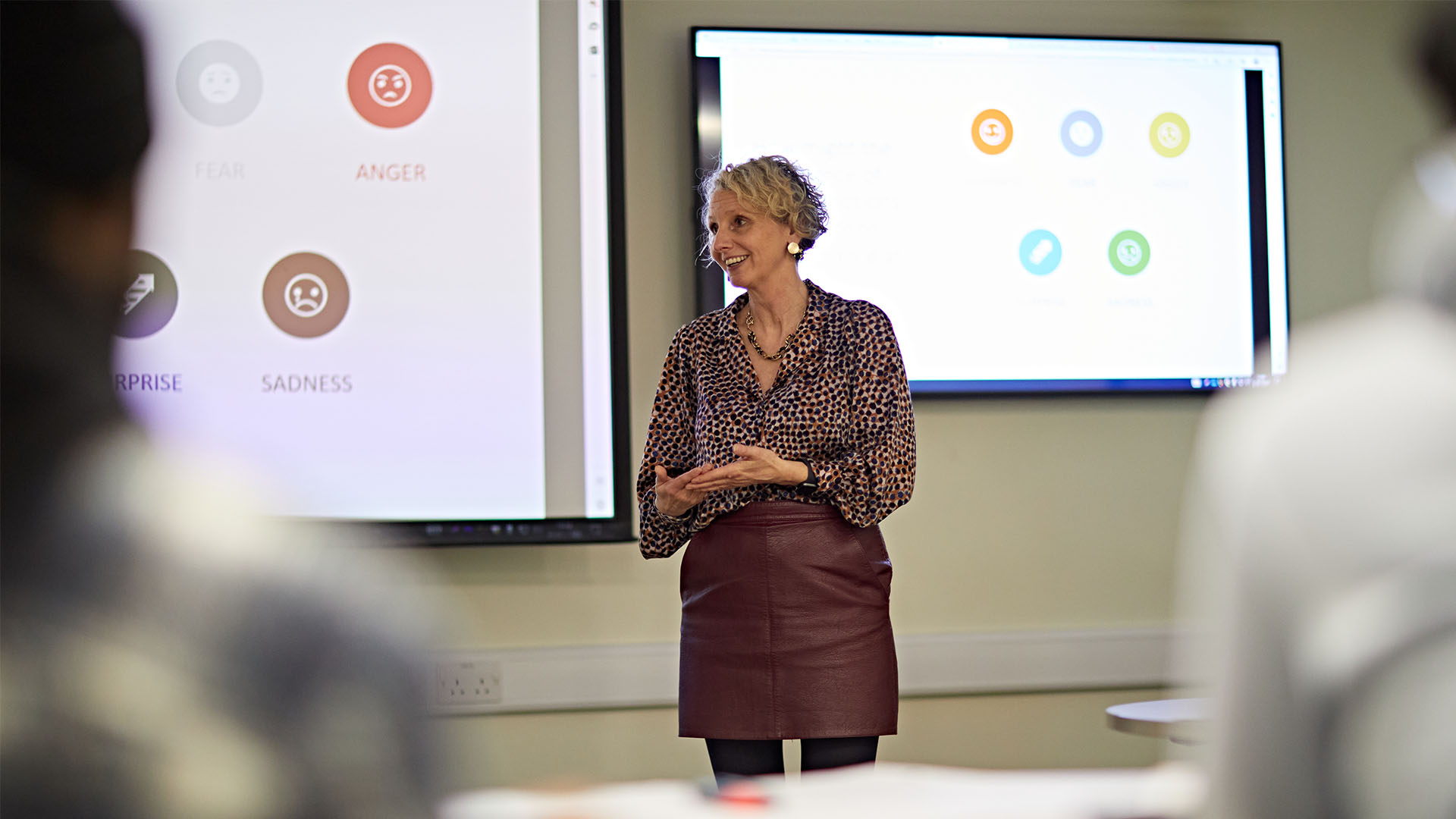 Lecturer speaking infront of a large whiteboard