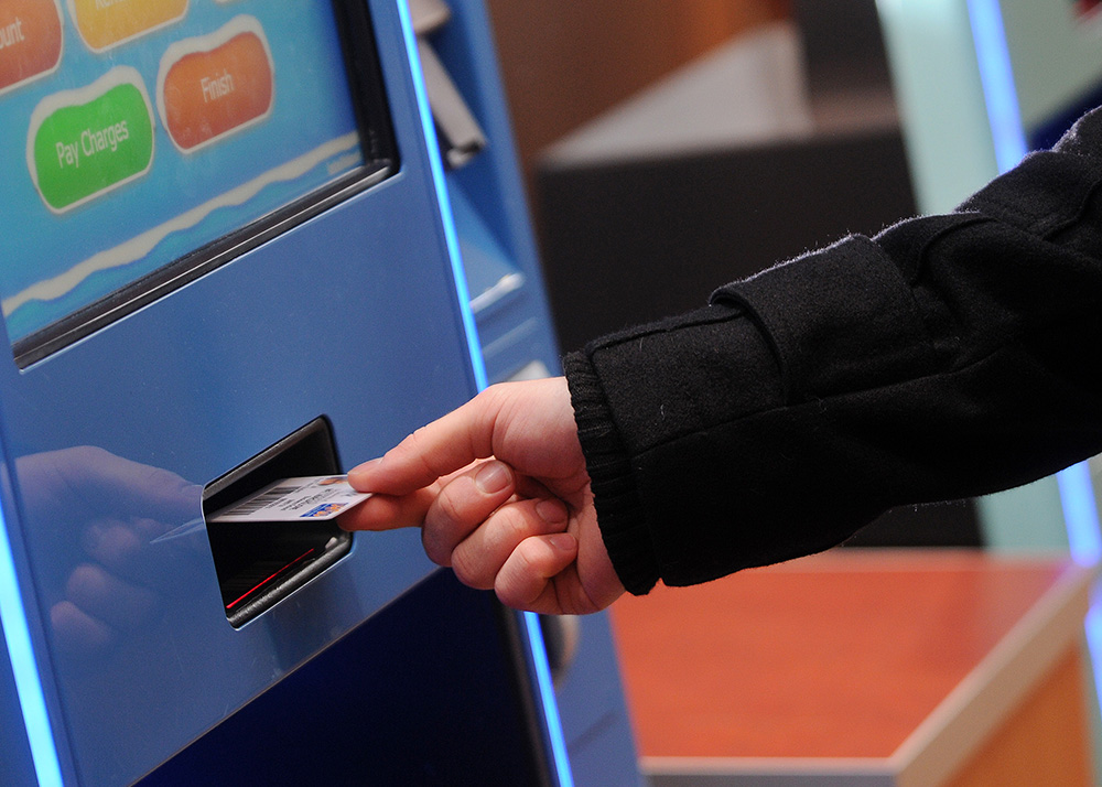 Student using campus card in self-service machine