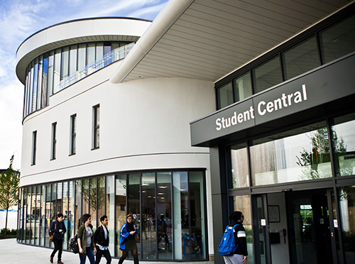 The Front door of Student Central - one of our University buildings with a number of facilities housed under one roof. The photo pictures students walking into the building.