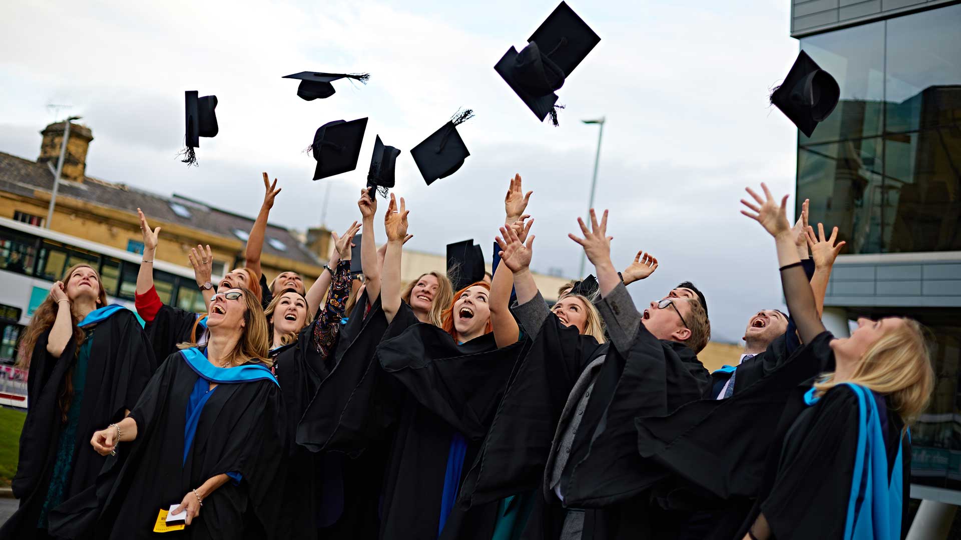Graduates throwing there mortarboards aloft after a graduation ceremony 