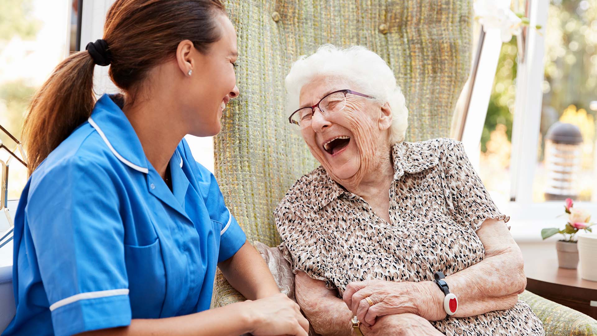 Old woman cackling with nurse