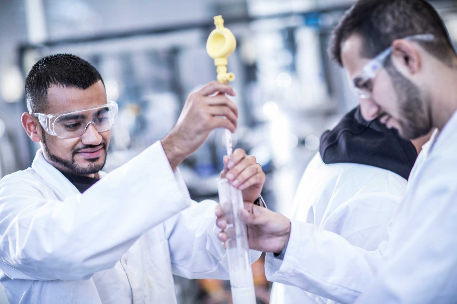 Two applied science students working in the lab with lab coats